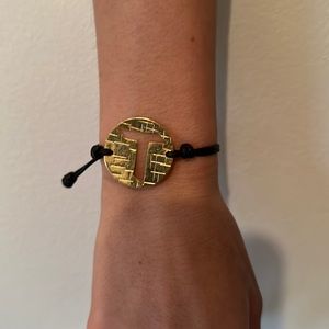 Leather bracelet band with a gold plated letter T.